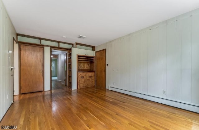 708 Carlene Dr, Bridgewater Twp, NJ 08807 - unfurnished bedroom featuring a baseboard heating unit and wood finished floors