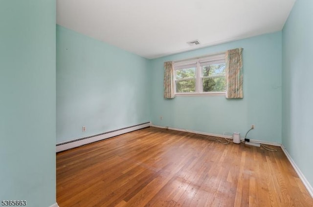 708 Carlene Dr, Bridgewater Twp, NJ 08807 - unfurnished room with baseboard heating and hardwood / wood-style floors
