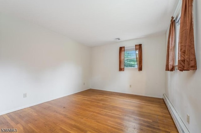 708 Carlene Dr, Bridgewater Twp, NJ 08807 - empty room with a baseboard radiator and wood finished floors