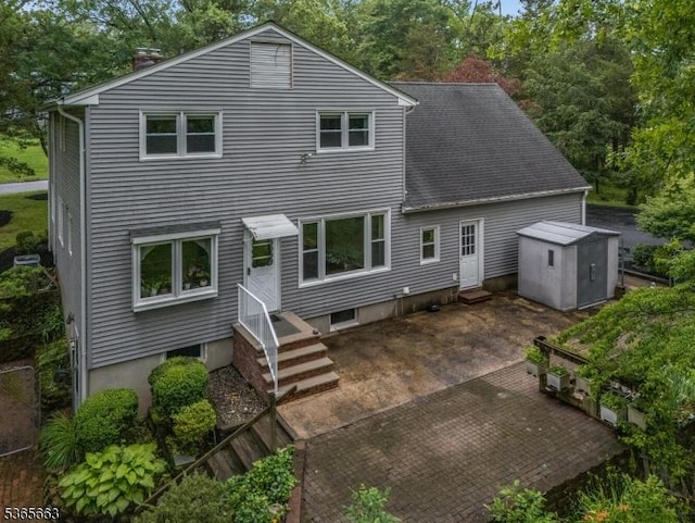 708 Carlene Dr, Bridgewater Twp, NJ 08807 - back of house featuring entry steps, a shed, a chimney, a patio, and view of wooded area