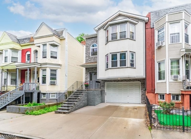 112-114 N 13th St, Newark City, NJ 07107 - multi unit property featuring stone siding, driveway, a garage, cooling unit, and stairs
