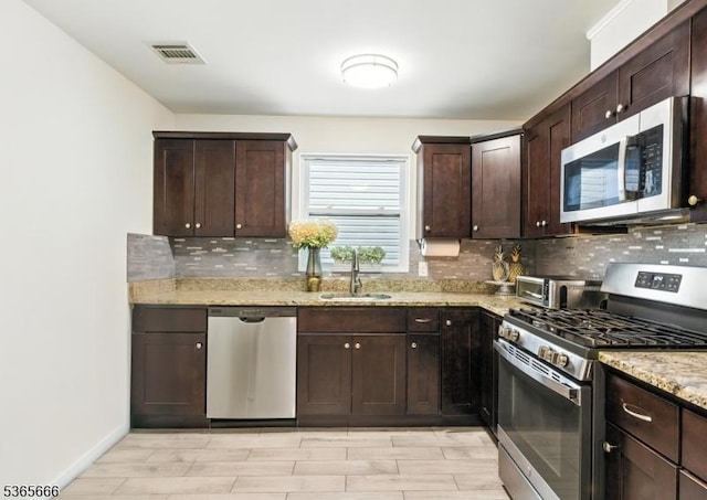 112-114 N 13th St, Newark City, NJ 07107 - kitchen with stainless steel appliances, tasteful backsplash, dark brown cabinets, light stone countertops, and light wood-type flooring