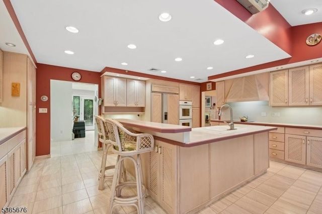 1503 Woodacres Dr, Mountainside Boro, NJ 07092 - kitchen with paneled built in refrigerator, light countertops, a breakfast bar, premium range hood, and recessed lighting