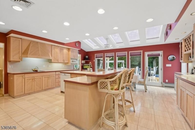 1503 Woodacres Dr, Mountainside Boro, NJ 07092 - kitchen with a skylight, white appliances, light brown cabinetry, light tile patterned floors, and recessed lighting