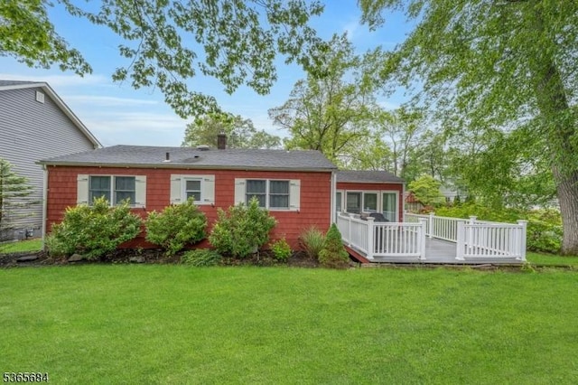 16 Ridgewood Pkwy W, Denville Twp, NJ 07834 - rear view of house featuring a yard, a deck, and a chimney