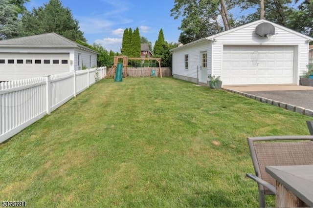 23 Brookside Ave, Hawthorne Boro, NJ 07506 - view of yard featuring a garage, an outbuilding, and a playground