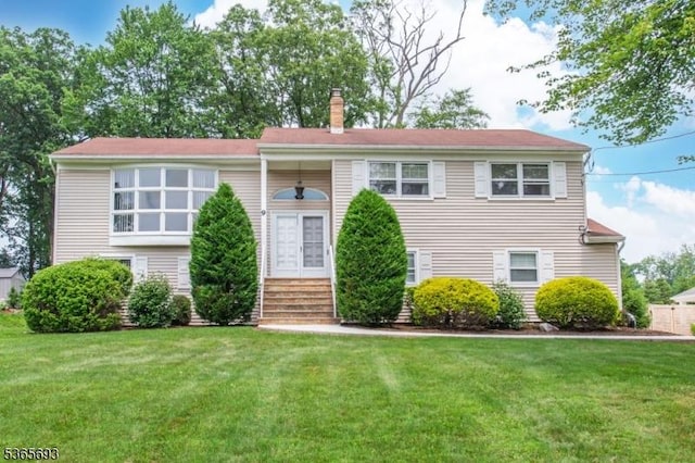 9 Andrea Ter, East Hanover Twp, NJ 07936 - raised ranch with entry steps, a front lawn, and a chimney
