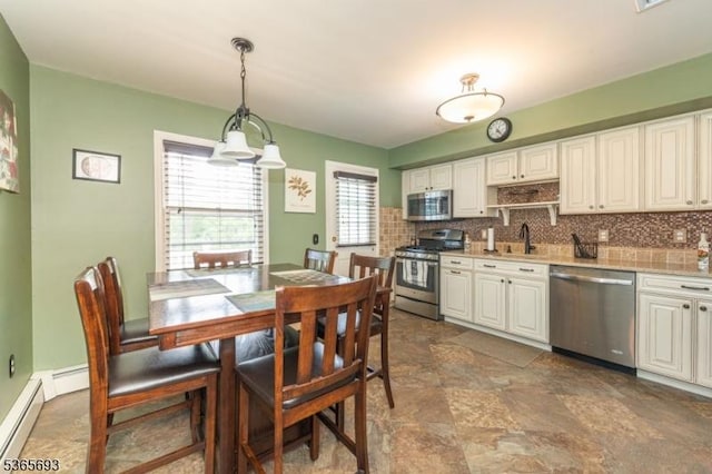 9 Andrea Ter, East Hanover Twp, NJ 07936 - kitchen featuring stainless steel appliances, backsplash, light countertops, pendant lighting, and white cabinetry