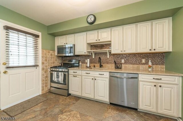 9 Andrea Ter, East Hanover Twp, NJ 07936 - kitchen featuring stainless steel appliances, dark stone finish flooring, white cabinetry, tasteful backsplash, and open shelves