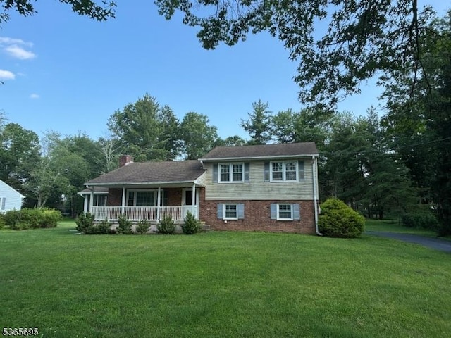 508 Stony Brook Dr, Bridgewater Twp, NJ 08807 - split level home with a porch, a front lawn, a chimney, and brick siding