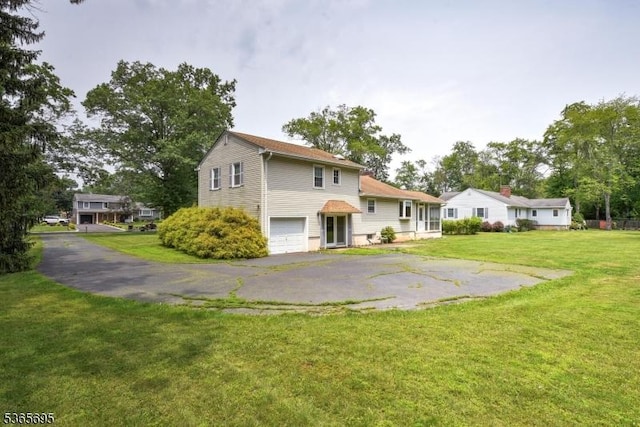 508 Stony Brook Dr, Bridgewater Twp, NJ 08807 - rear view of house featuring a garage, asphalt driveway, and a lawn