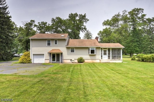508 Stony Brook Dr, Bridgewater Twp, NJ 08807 - back of property featuring a garage, a chimney, a sunroom, asphalt driveway, and a lawn