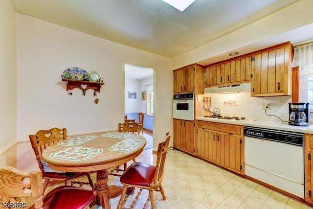 508 Stony Brook Dr, Bridgewater Twp, NJ 08807 - kitchen featuring white appliances, light countertops, light flooring, under cabinet range hood, and brown cabinets