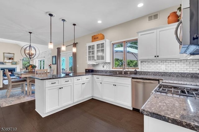 6 White Rd, Raritan Twp, NJ 08822 - kitchen with appliances with stainless steel finishes, a peninsula, dark wood-style floors, white cabinetry, and glass insert cabinets