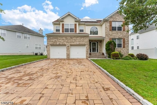 8 Cobblers Cir, Franklin Twp, NJ 08823 - view of front facade with solar panels, decorative driveway, a front yard, and brick siding