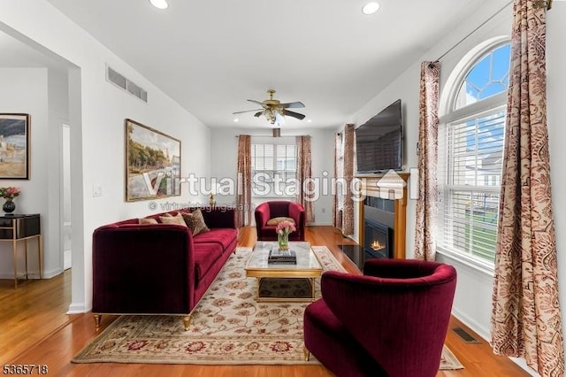 8 Cobblers Cir, Franklin Twp, NJ 08823 - living area with a fireplace with flush hearth, recessed lighting, wood finished floors, and a ceiling fan