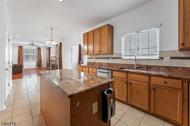 8 Cobblers Cir, Franklin Twp, NJ 08823 - kitchen featuring light tile patterned flooring, a kitchen island, and brown cabinetry