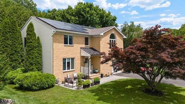 825 Odonnell Ave, Scotch Plains Twp, NJ 07076 - rear view of property with roof mounted solar panels, brick siding, and a yard