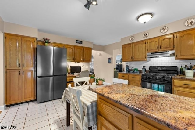 825 Odonnell Ave, Scotch Plains Twp, NJ 07076 - kitchen with freestanding refrigerator, black gas stove, under cabinet range hood, backsplash, and light tile patterned floors