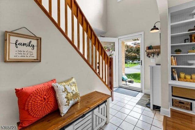 825 Odonnell Ave, Scotch Plains Twp, NJ 07076 - foyer featuring healthy amount of natural light, stairway, light tile patterned floors, and a towering ceiling