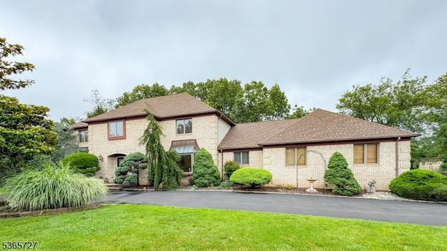 15 Michael Ln, Scotch Plains Twp, NJ 07076 - view of front of house with a front yard, brick siding, and roof with shingles