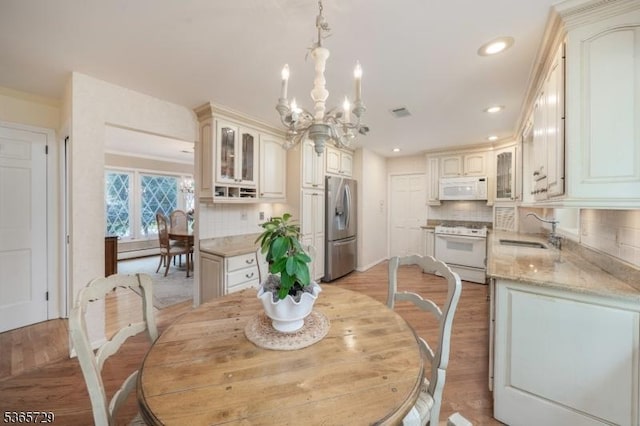 73 Garden Ave, Chatham Boro, NJ 07928 - dining space with a chandelier, light wood-style floors, and recessed lighting