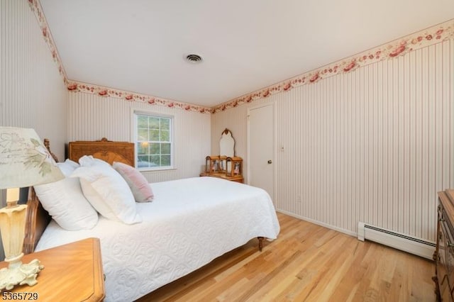 73 Garden Ave, Chatham Boro, NJ 07928 - bedroom with baseboard heating, wood finished floors, and wallpapered walls