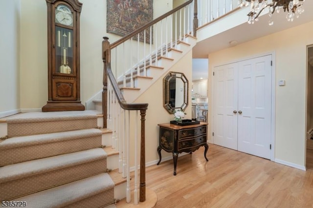 73 Garden Ave, Chatham Boro, NJ 07928 - stairway featuring wood finished floors, a chandelier, and a towering ceiling