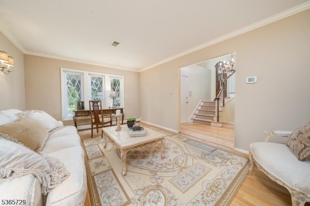 73 Garden Ave, Chatham Boro, NJ 07928 - living area with light wood finished floors, crown molding, and stairway