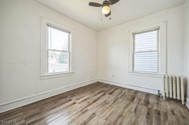 522 Locust Ave, Hillside Twp, NJ 07205 - unfurnished room featuring radiator, wood finished floors, and a ceiling fan
