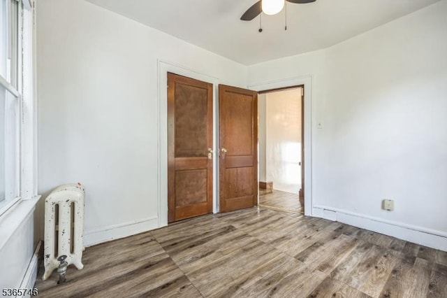 522 Locust Ave, Hillside Twp, NJ 07205 - unfurnished bedroom featuring radiator heating unit, wood finished floors, and a ceiling fan