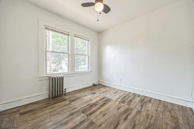 522 Locust Ave, Hillside Twp, NJ 07205 - spare room with radiator heating unit, wood finished floors, and ceiling fan