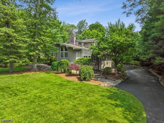 11 Rising Ridge Rd, Upper Saddle River Boro, NJ 07458 - view of front facade featuring a chimney, asphalt driveway, and a front yard