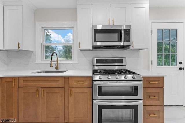 1837 Barnett St, Rahway City, NJ 07065 - kitchen featuring appliances with stainless steel finishes, light countertops, tasteful backsplash, and plenty of natural light