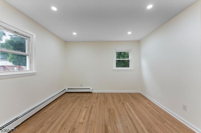 1837 Barnett St, Rahway City, NJ 07065 - unfurnished room with a baseboard heating unit, light wood finished floors, recessed lighting, and a baseboard radiator