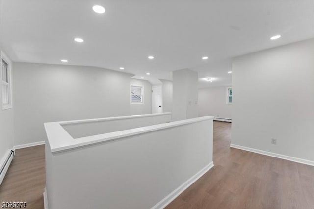 1837 Barnett St, Rahway City, NJ 07065 - corridor featuring wood finished floors, recessed lighting, a baseboard heating unit, and an upstairs landing