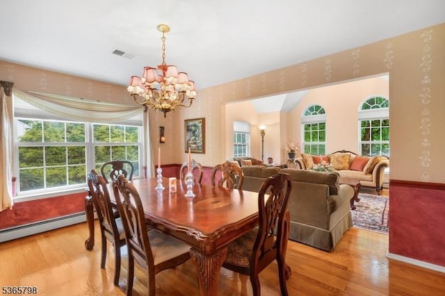 12 Autumn Dr, Mine Hill Twp, NJ 07803 - dining space with a chandelier and light wood-style flooring