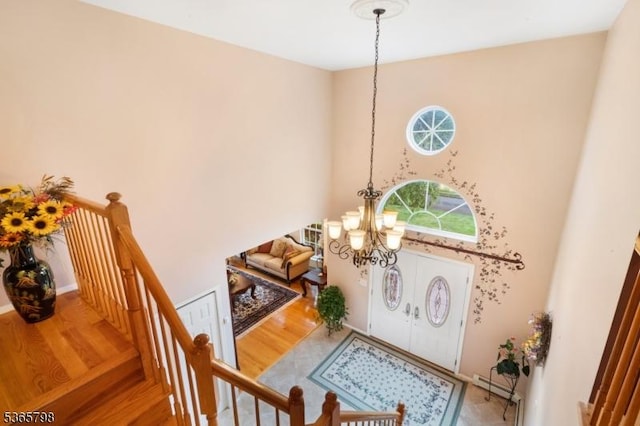 12 Autumn Dr, Mine Hill Twp, NJ 07803 - entrance foyer featuring a chandelier, wood finished floors, a high ceiling, and baseboard heating