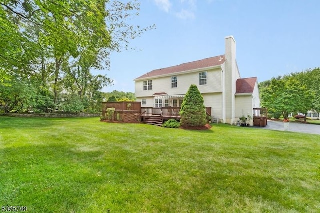 12 Autumn Dr, Mine Hill Twp, NJ 07803 - rear view of property featuring a chimney, a wooden deck, and a lawn