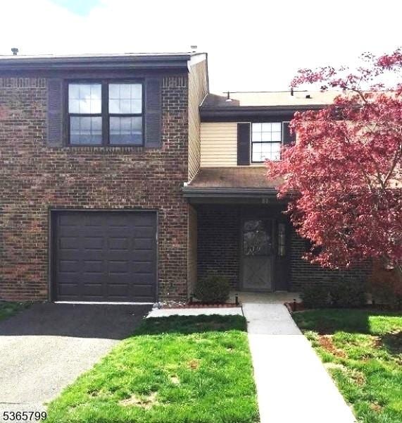 81 Stanwick Ct, Franklin Twp, NJ 08873 - view of front facade featuring a garage, driveway, and brick siding