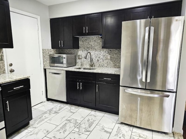 81 Stanwick Ct, Franklin Twp, NJ 08873 - kitchen featuring stainless steel appliances, dark cabinets, light marble finish flooring, light stone countertops, and tasteful backsplash