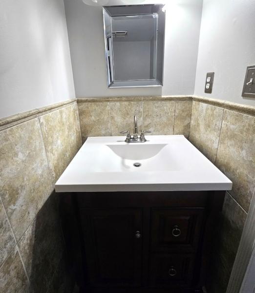 81 Stanwick Ct, Franklin Twp, NJ 08873 - bathroom featuring tile walls, vanity, and wainscoting