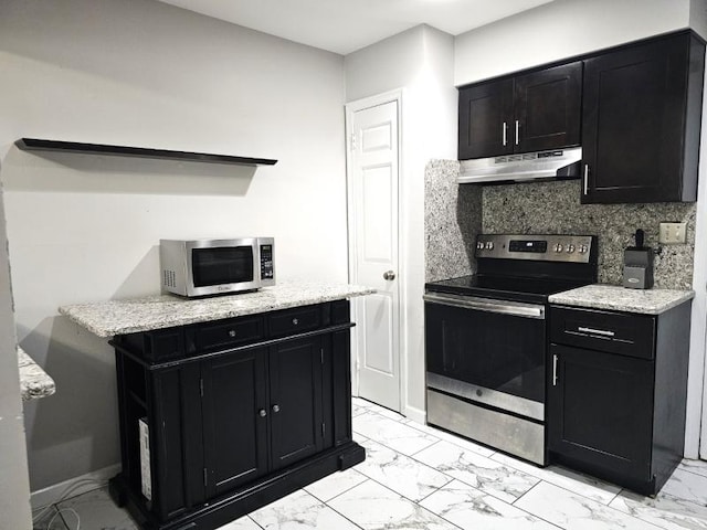 81 Stanwick Ct, Franklin Twp, NJ 08873 - kitchen with stainless steel appliances, under cabinet range hood, dark cabinetry, light marble finish flooring, and tasteful backsplash