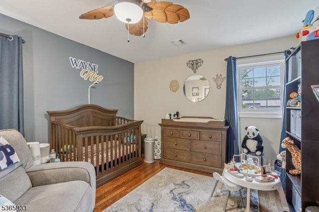 95 Harrison Ave, North Plainfield Boro, NJ 07060 - bedroom with wood finished floors, a nursery area, and a ceiling fan