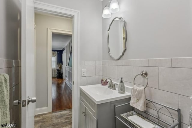 95 Harrison Ave, North Plainfield Boro, NJ 07060 - bathroom featuring vanity, wood finished floors, a wainscoted wall, and tile walls