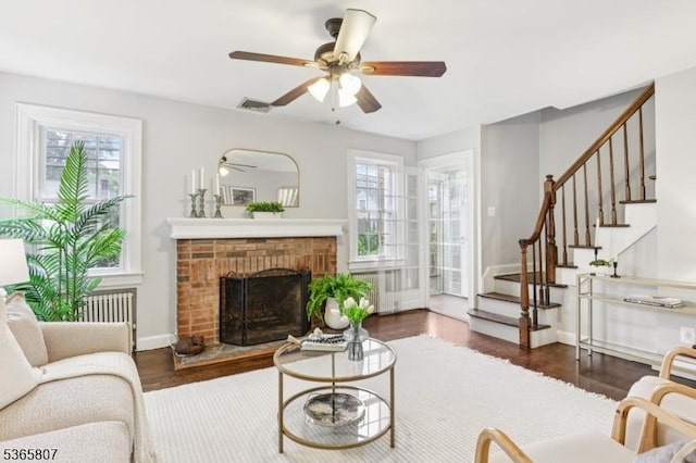 213 Columbia Ave, Cranford Twp, NJ 07016 - living room with a ceiling fan, stairs, radiator, a brick fireplace, and wood finished floors