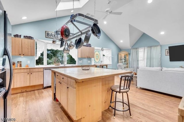 9 Mueller Ln, Franklin Twp, NJ 07882 - kitchen featuring light brown cabinets, vaulted ceiling, light countertops, light wood-style flooring, and a kitchen breakfast bar