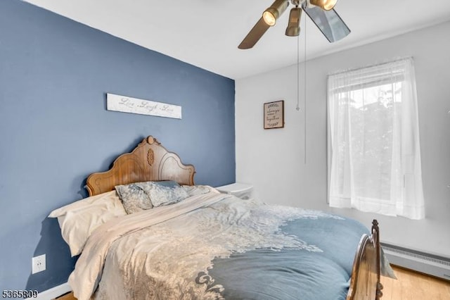 9 Mueller Ln, Franklin Twp, NJ 07882 - bedroom with baseboard heating, a ceiling fan, and wood finished floors