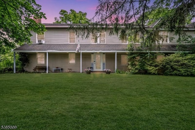 9 Mueller Ln, Franklin Twp, NJ 07882 - back of house at dusk featuring a lawn, a chimney, and a porch