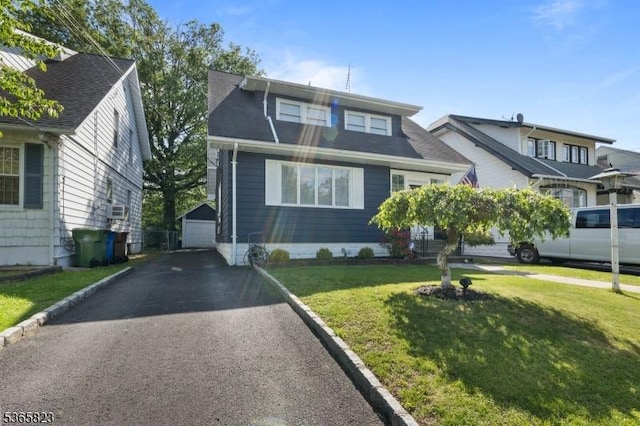 905 Dewitt St, Linden City, NJ 07036 - view of front of house with an outbuilding, a front lawn, a detached garage, and driveway